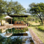 Luxury tented safari camp overlooking the Serengeti plains at sunset in Grumeti Reserve, Tanzania.