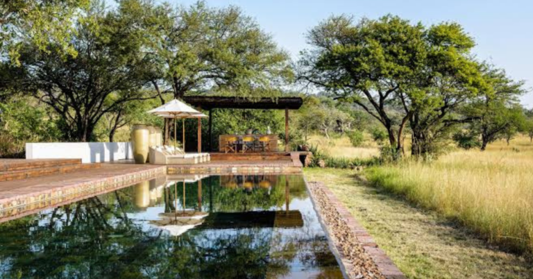 Luxury tented safari camp overlooking the Serengeti plains at sunset in Grumeti Reserve, Tanzania.