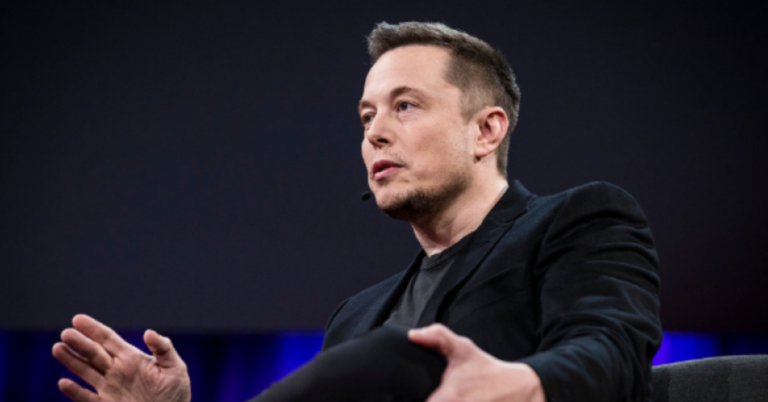 Elon Musk stands in front of a SpaceX Starship rocket ahead of the company’s historic IPO filing.