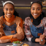Lebo and Tebo Ndala posing in a modern kitchen during the launch of Twice as Nice – With Love From The Twins on The Home Channel.