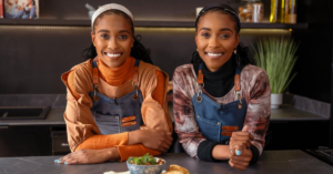 Lebo and Tebo Ndala posing in a modern kitchen during the launch of Twice as Nice – With Love From The Twins on The Home Channel.